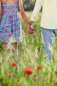 Romantic young couple holding hands on a date.